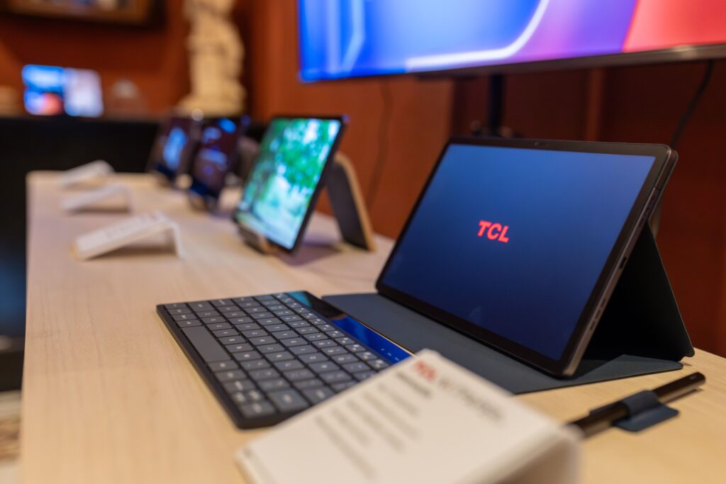 Close-up view of tablets with keyboards in a contemporary electronics store setting.