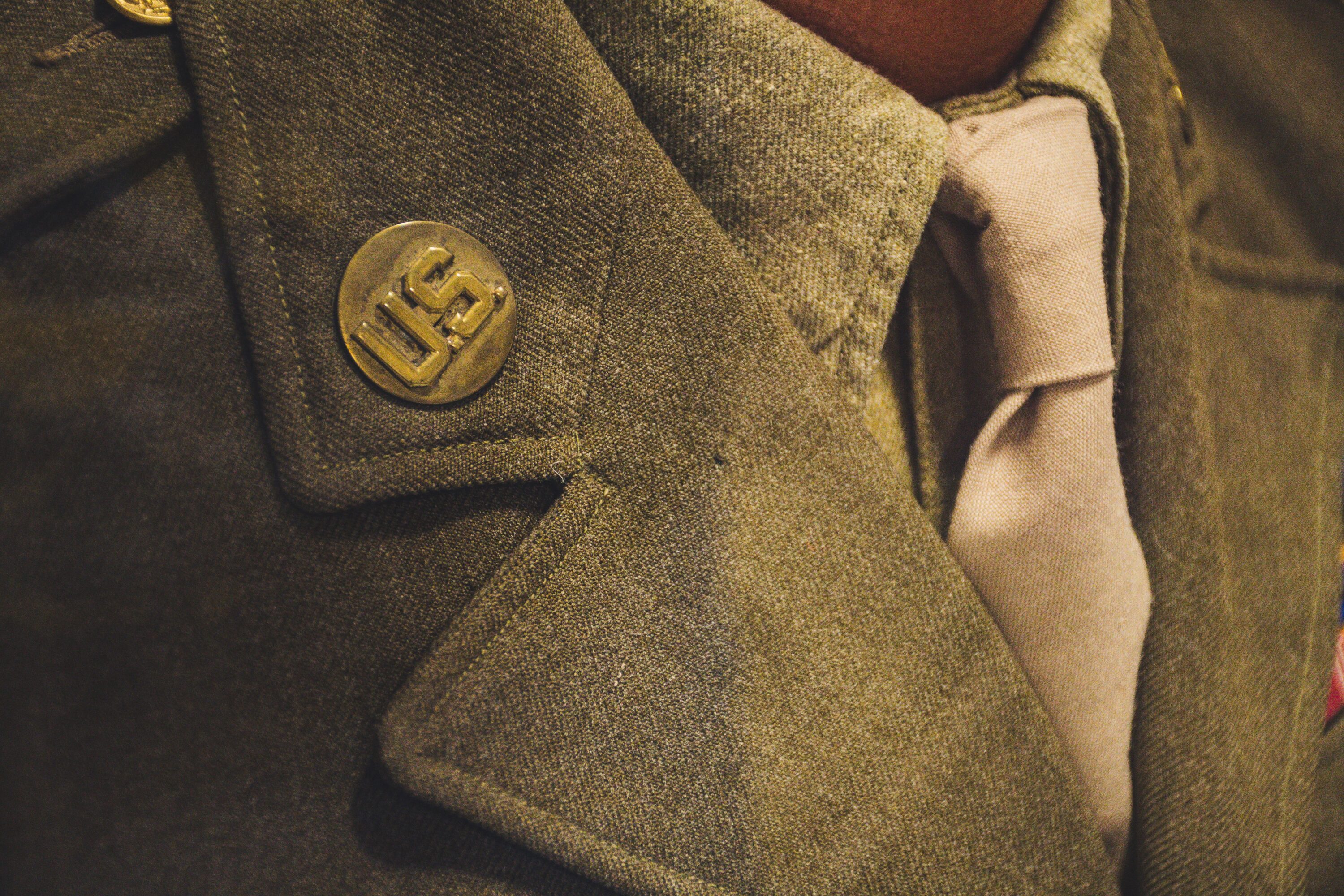 Detailed shot of a US military jacket showcasing button and tie.